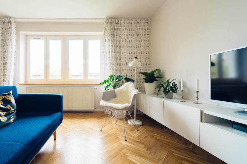 UK flat with white cast iron radiators under sash windows