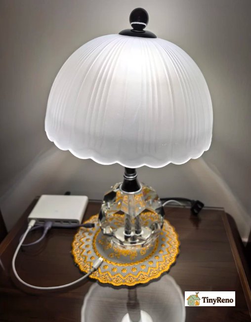 A small reading lamp on a desk or bedside table